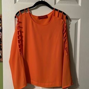 Beautiful orange shirt with open slots on sleeves